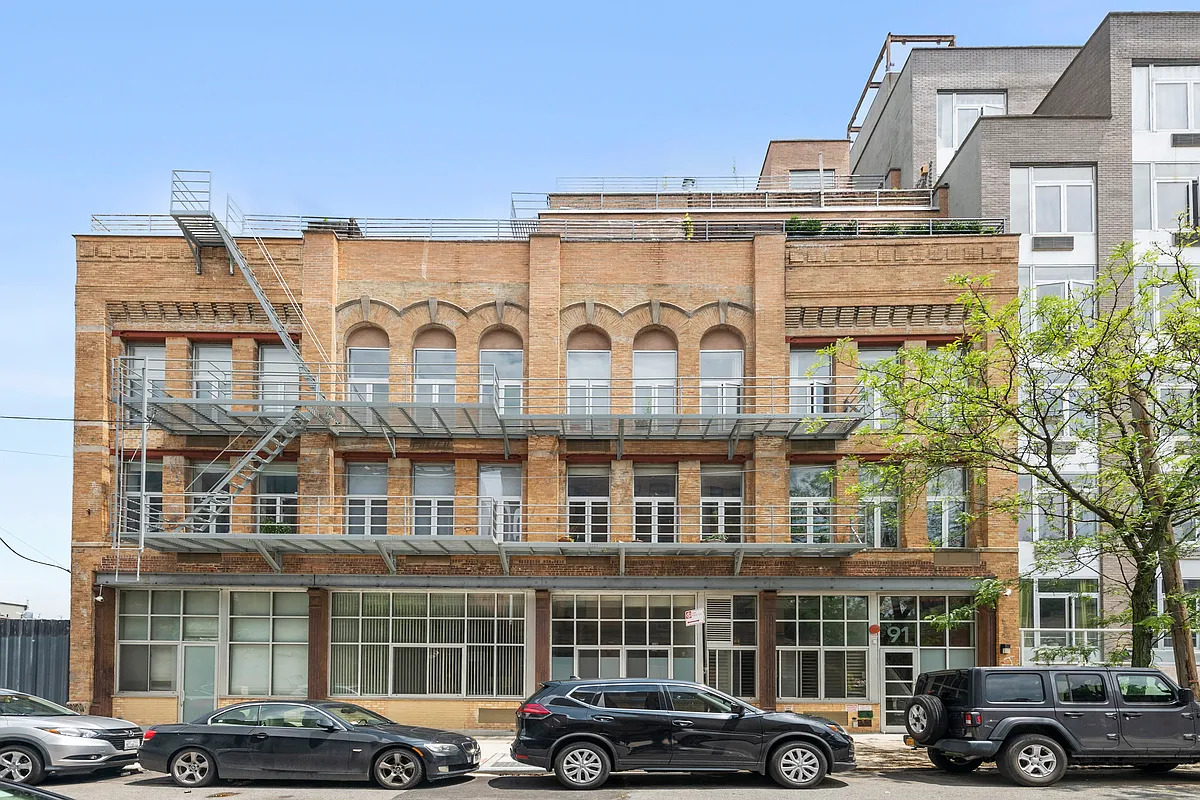 91 Grand Avenue, Unit 2D Brooklyn, NY 11205 - Photo 15 of 16 a front view of a building with parking space