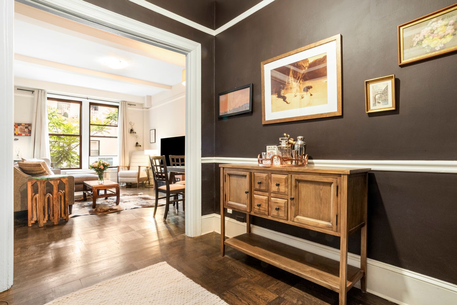 114 West 70th Street, Unit 3D Manhattan, NY 10023 - Photo 2 of 9 a living room with furniture and wooden floor
