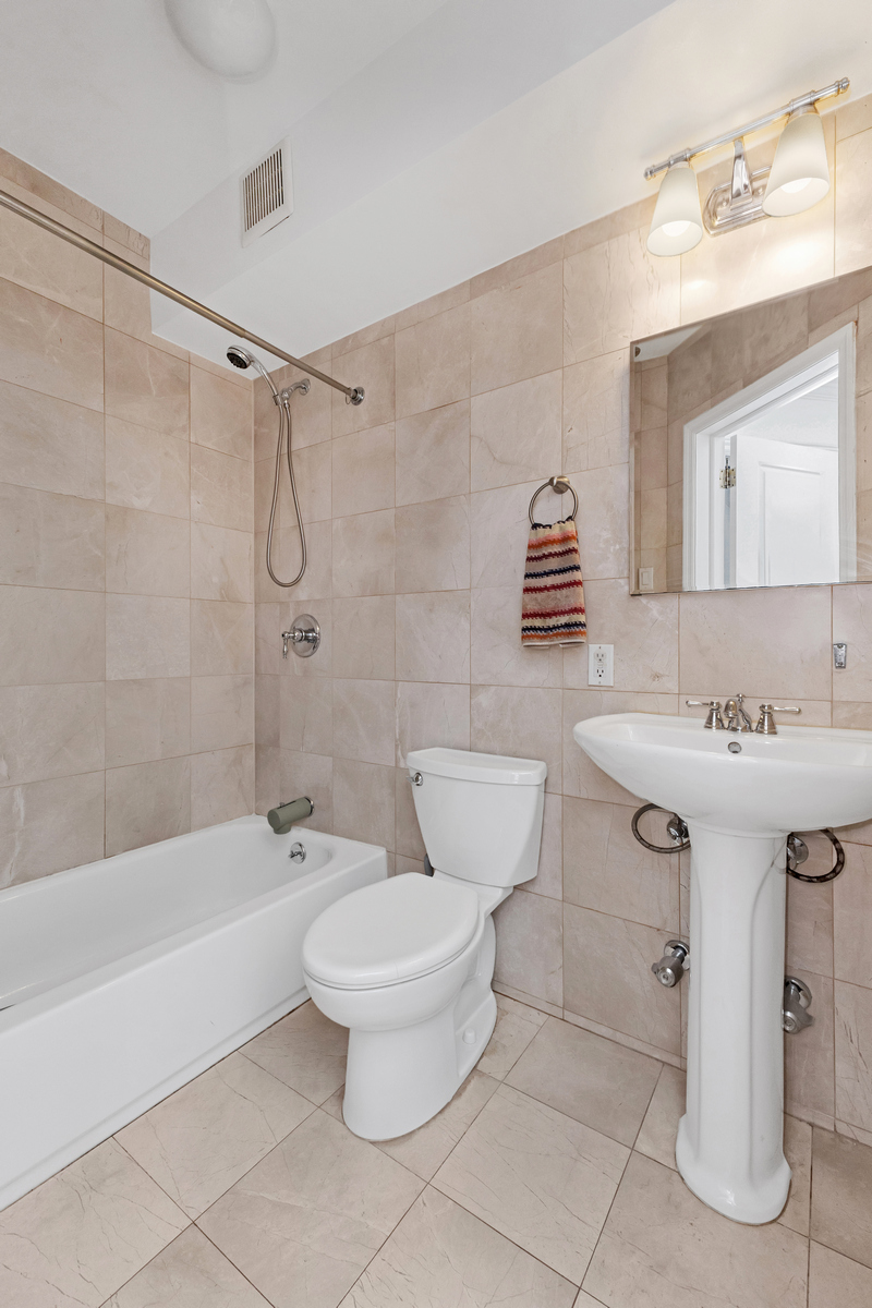 74 2nd Place, Unit 2B Brooklyn, NY 11231 - Photo 9 of 14 a bathroom with a sink toilet a mirror and shower