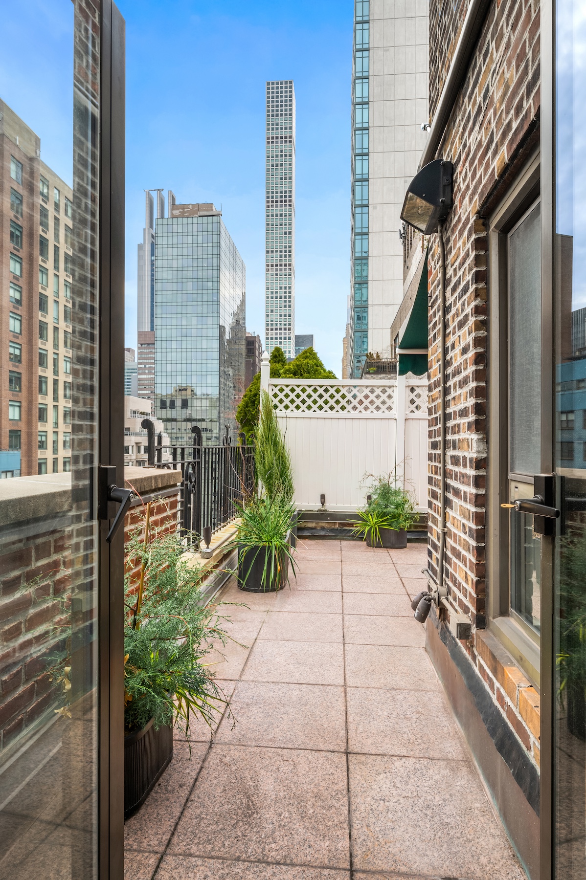 227 East 57th Street, Unit 18BF Manhattan, NY 10022 - Photo 3 of 17 a front view of a house with a garden
