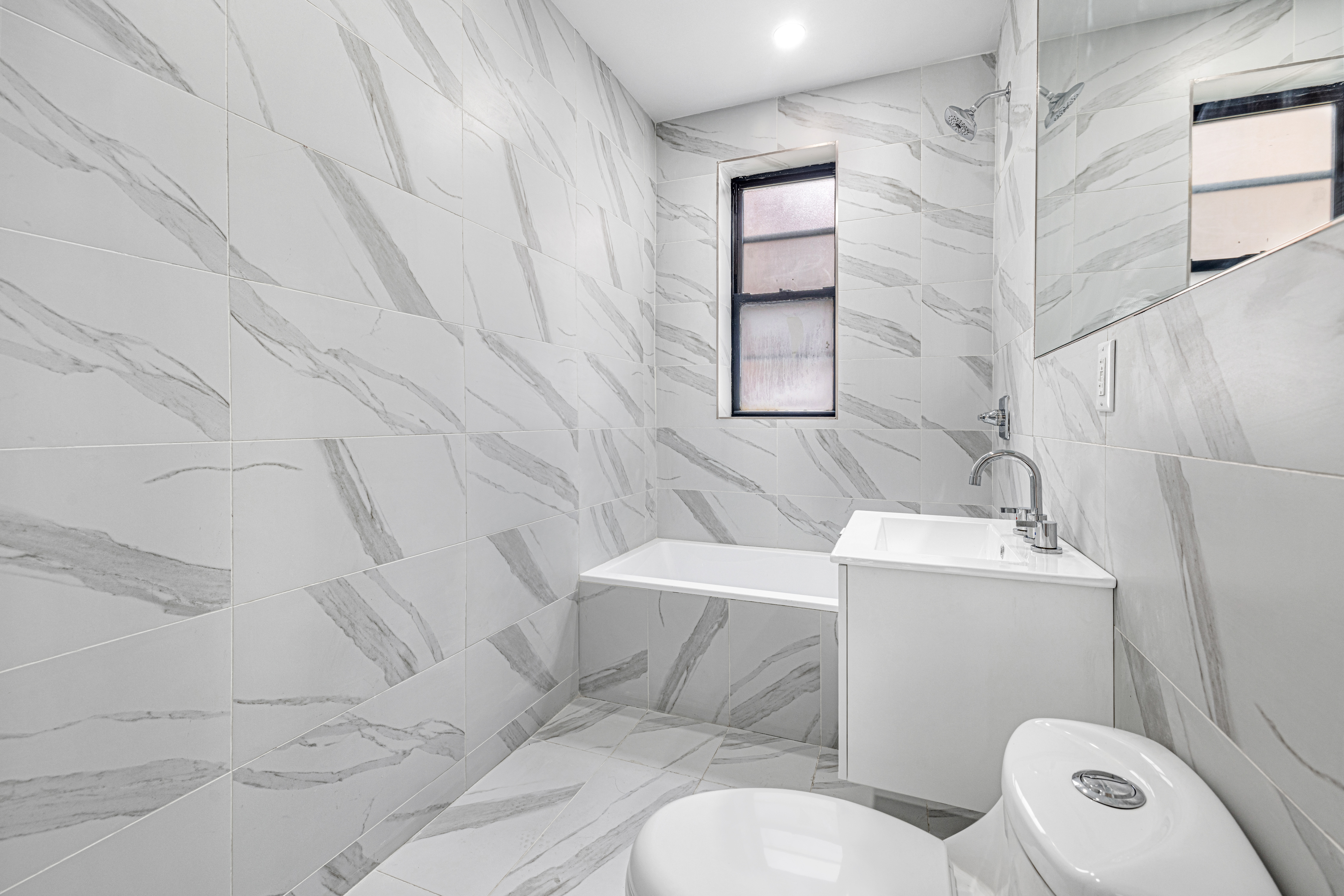 640 Ditmas Avenue, Unit 23 Brooklyn, NY 11218 - Photo 4 of 9 a white toilet sitting next to a bath tub