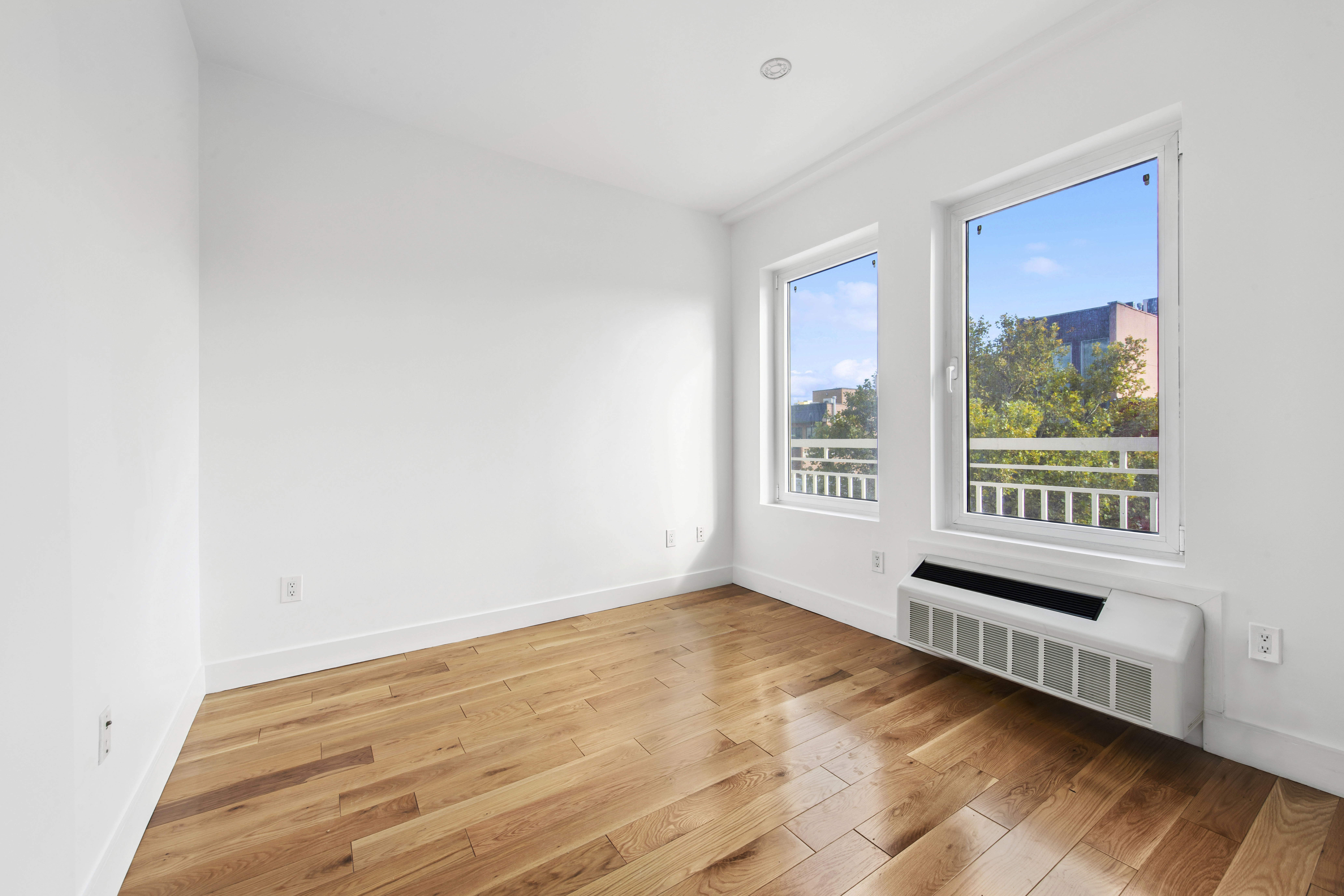 139 Skillman Avenue, Unit 4B Brooklyn, NY 11211 - Photo 9 of 19 a view of an empty room with wooden floor and a window