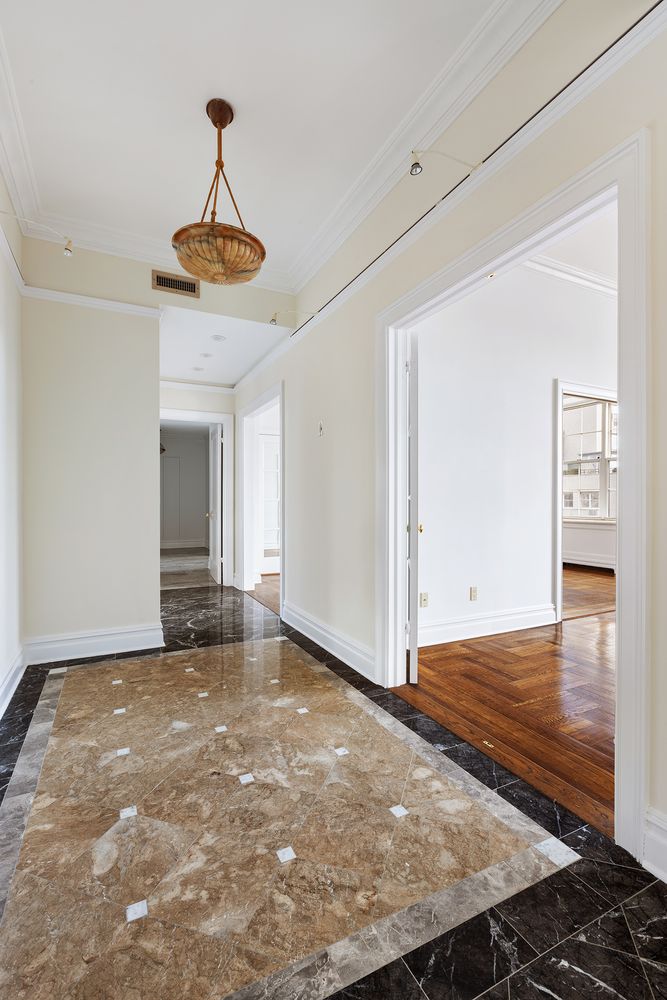 30 Sutton Place, Unit 14B Manhattan, NY 10022 - Photo 4 of 10 a view of an empty room with window and wooden floor