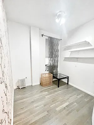 205 West 103rd Street, Unit 1C Manhattan, NY 10025 - Photo 3 of 5 a living room with furniture and wooden floor