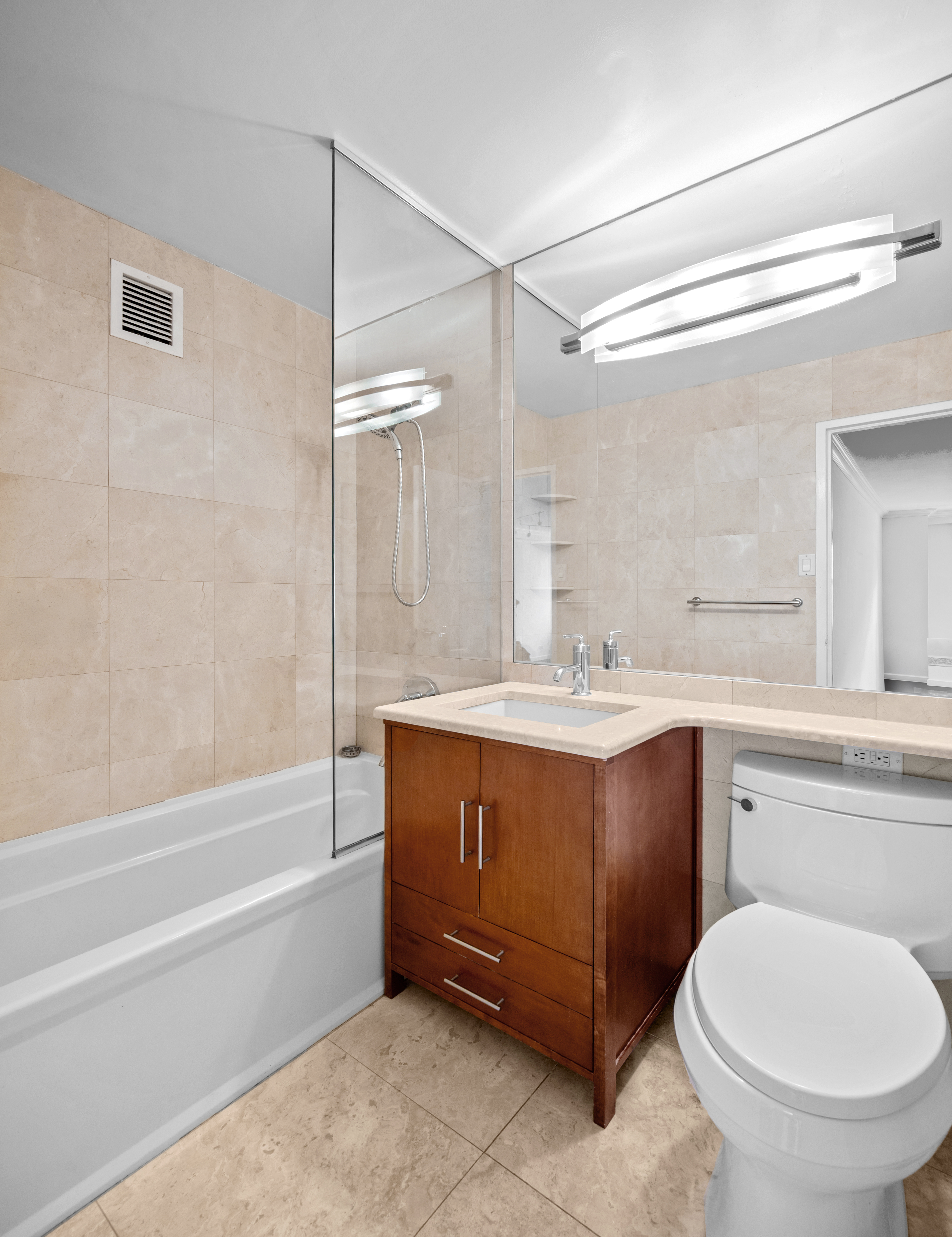 225 East 57th Street, Unit 14F Manhattan, NY 10022 - Photo 8 of 14 a bathroom with a sink toilet and shower