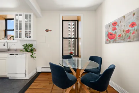 a dining room with furniture and window