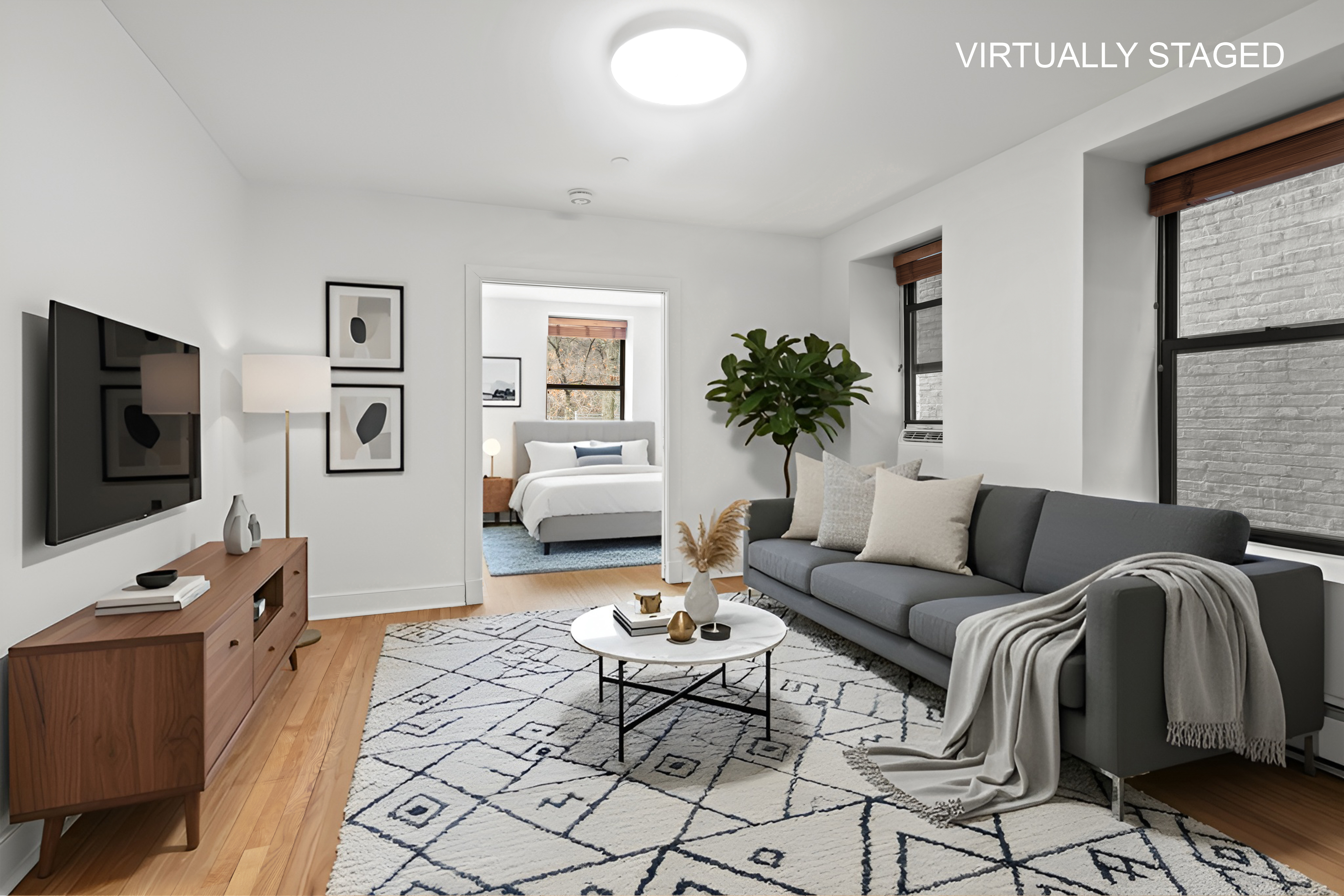 305 West 150th Street, Unit 206 Manhattan, NY 10039 - Photo 1 of 18 a living room with furniture and a flat screen tv