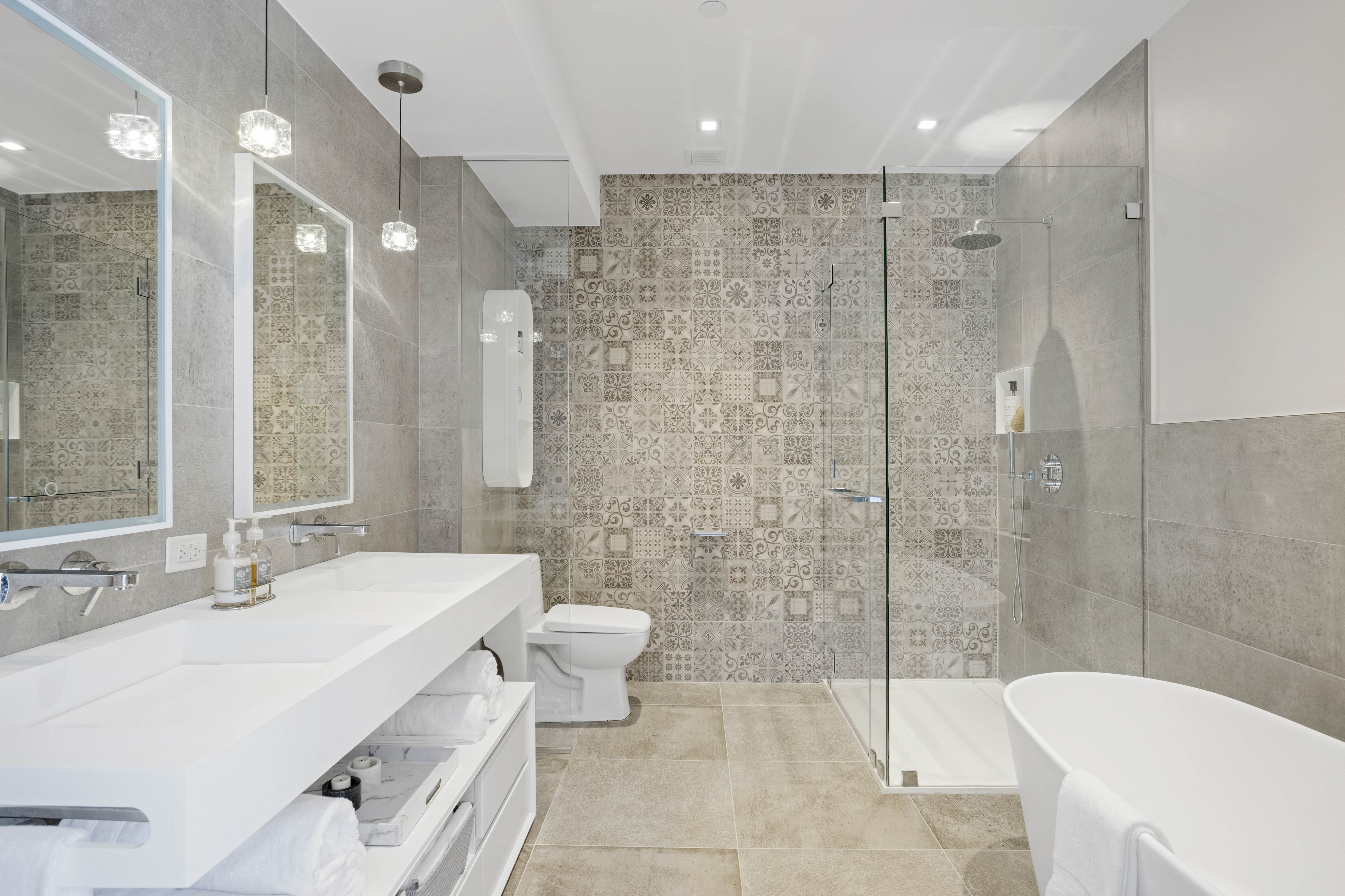 302 East 96th Street, Unit PH6 Manhattan, NY 10128 - Photo 9 of 13 a bathroom with a sink toilet a mirror and shower