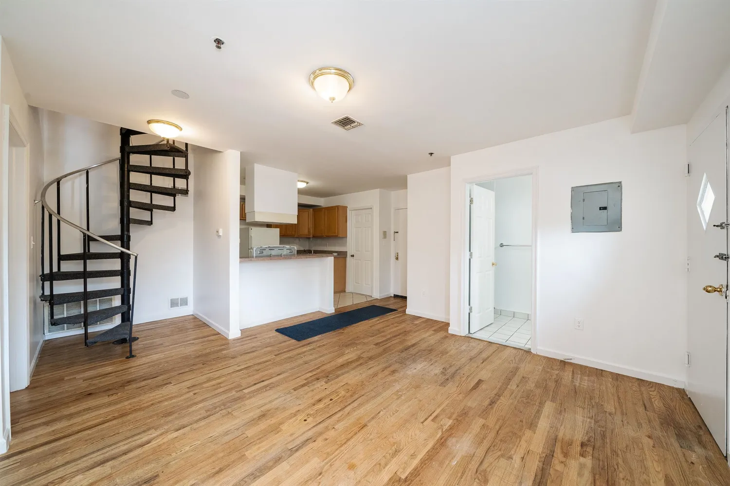 a view of a kitchen with wooden floor and electronic appliances