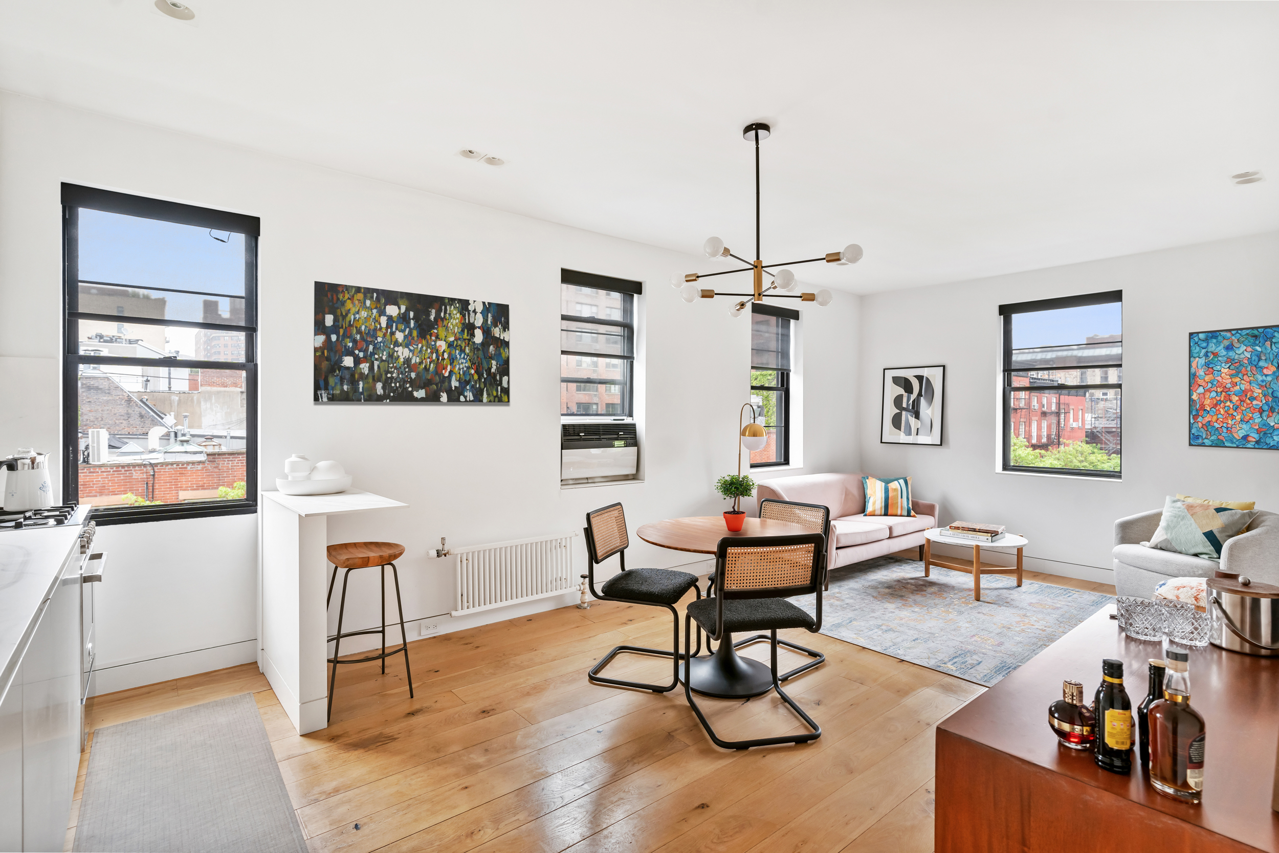 61 Horatio Street, Unit 5F Manhattan, NY 10014 - Photo 1 of 11 a living room with furniture a flat screen tv and a window