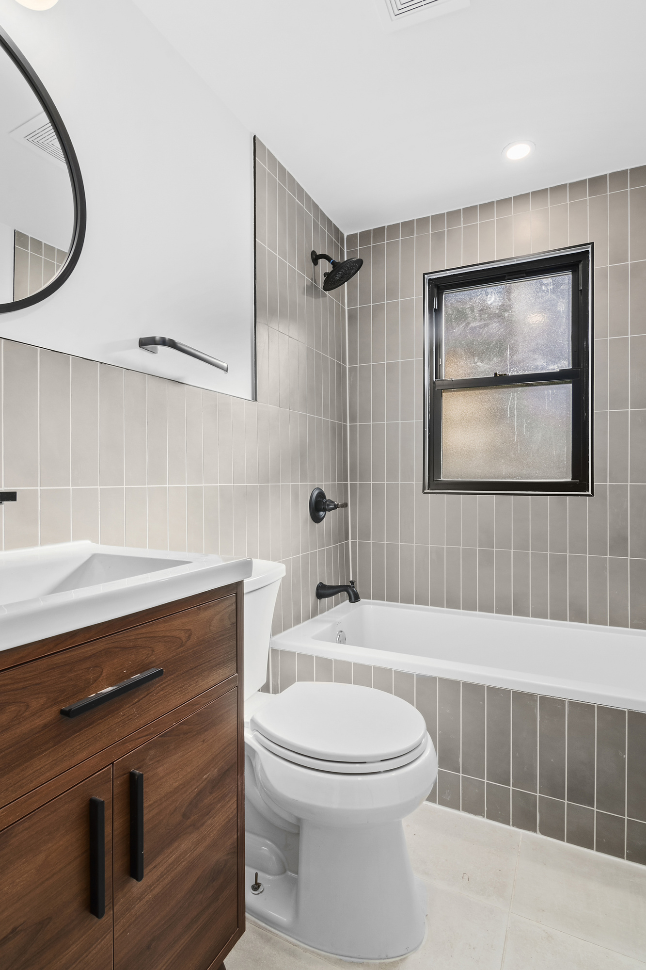 42 Eldert Street, Unit 1 Brooklyn, NY 11207 - Photo 7 of 10 a bathroom with a toilet a sink and bathtub