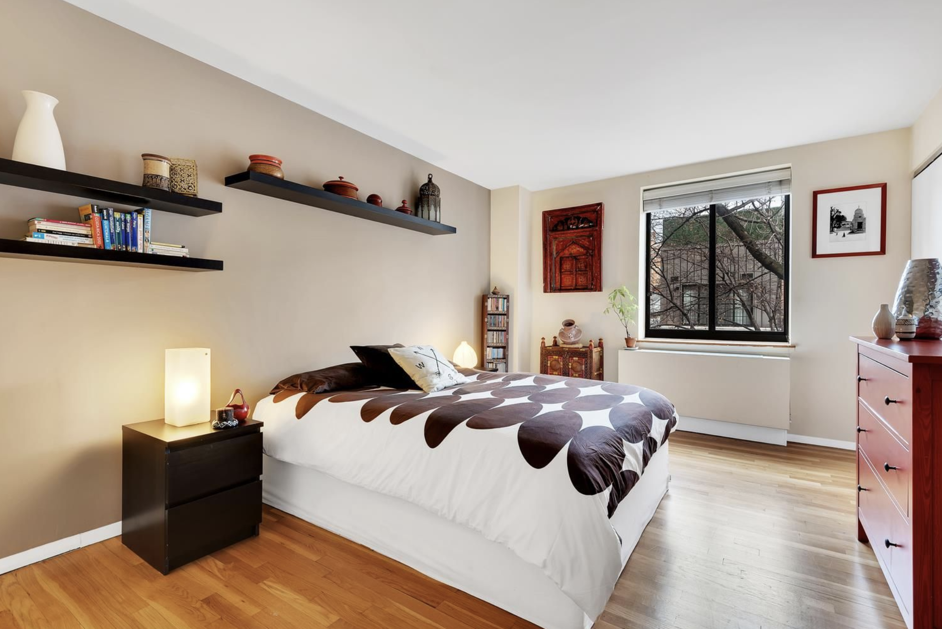 445 West 19th Street, Unit 5G Manhattan, NY 10011 - Photo 2 of 7 a bedroom with a bed and wooden floor