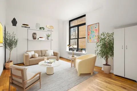 a living room with furniture and a potted plant