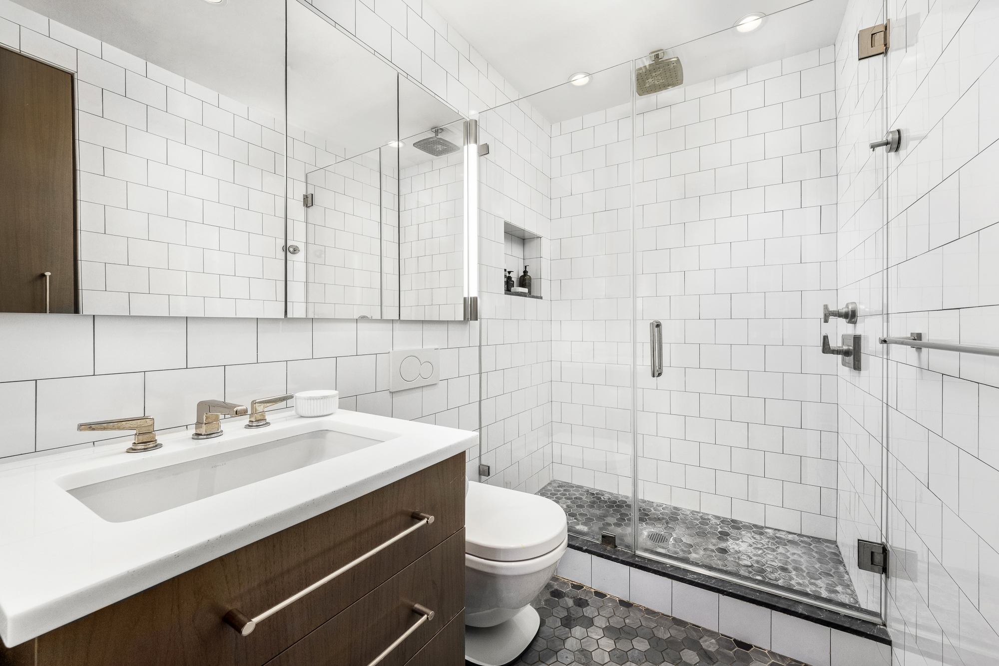 220 Madison Avenue, Unit 14/15O Manhattan, NY 10016 - Photo 15 of 18 a bathroom with a sink a toilet and shower