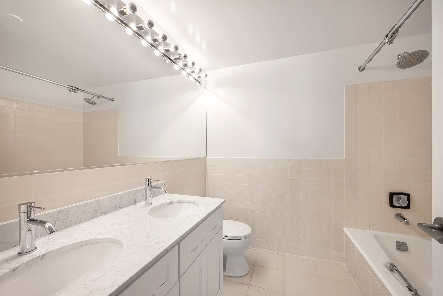 95 Greene Street, Unit 2F Manhattan, NY 10012 - Photo 6 of 8 a bathroom with a sink a toilet and shower