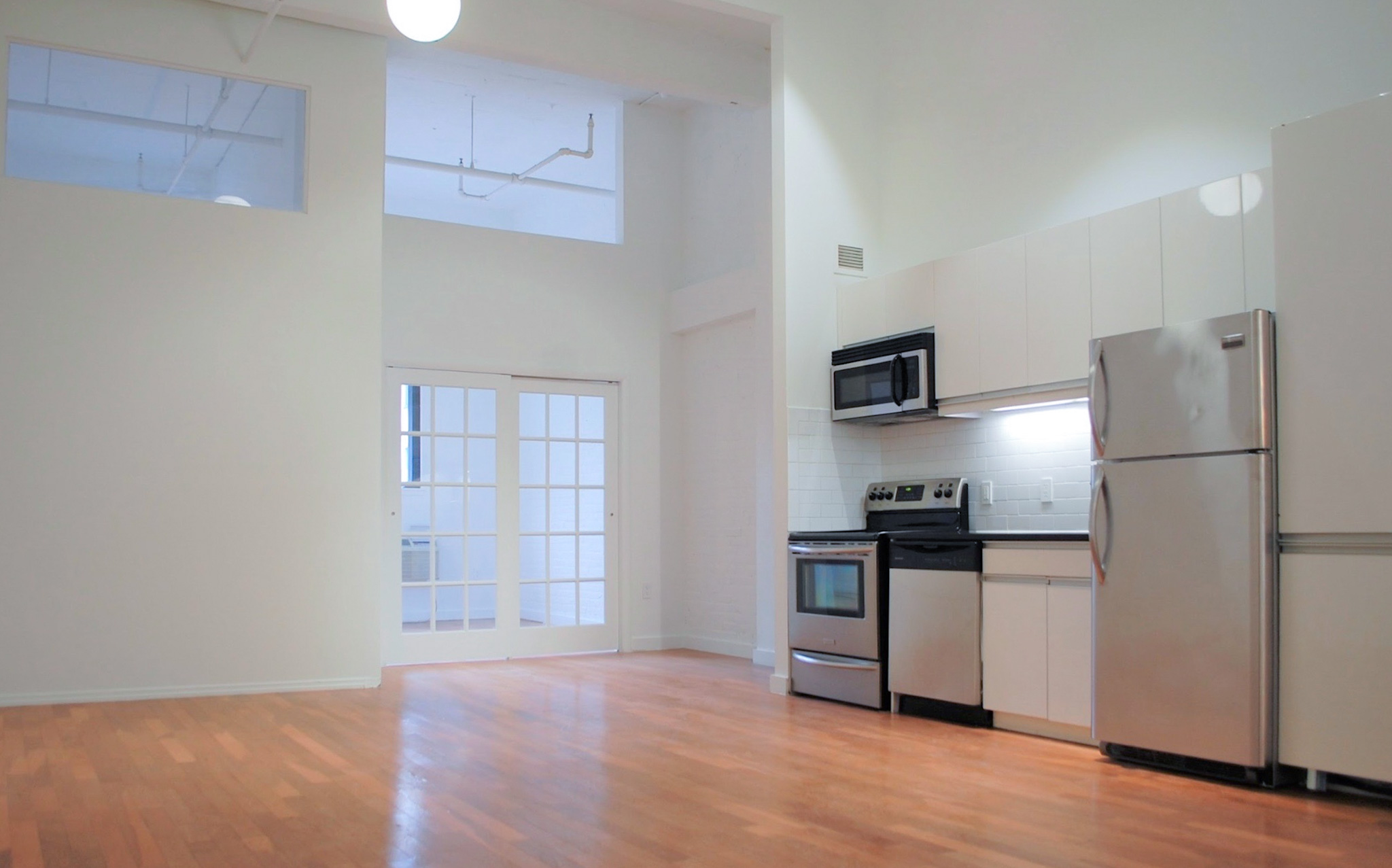 a kitchen with stainless steel appliances granite countertop a refrigerator and a stove top oven