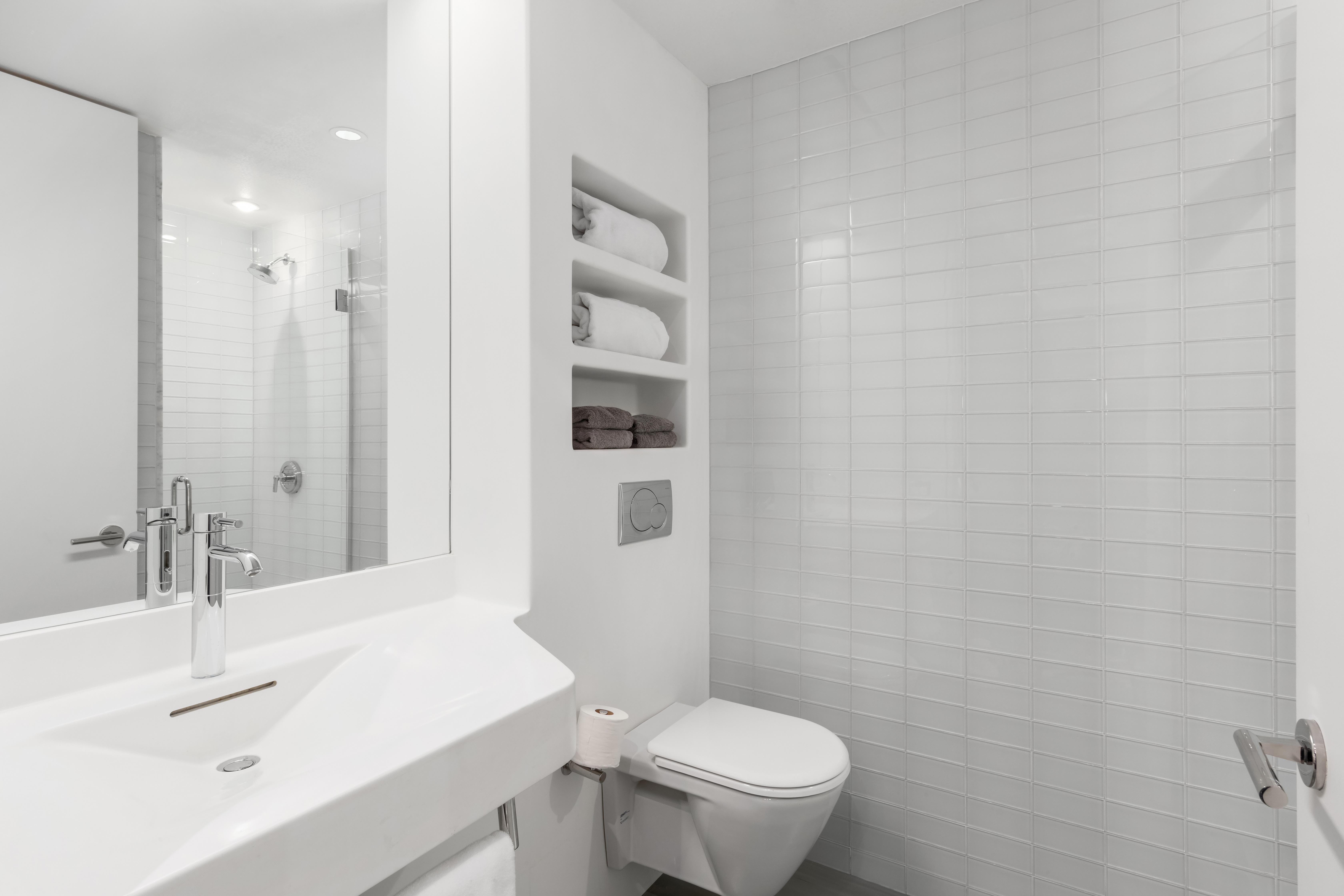 166 Perry Street, Unit 1B Manhattan, NY 10014 - Photo 10 of 17 a bathroom with a sink a toilet and shower