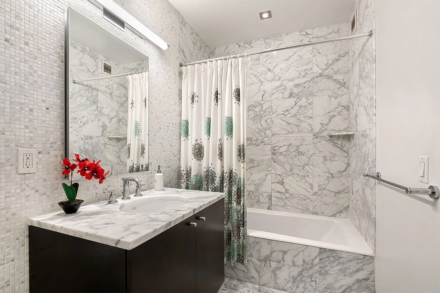 a bathroom with a granite countertop sink a bathtub and a shower