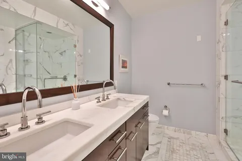 a bathroom with a double vanity sink mirror and double