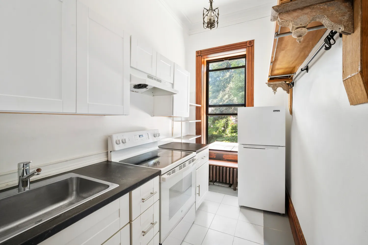 a kitchen with white cabinets and white appliances