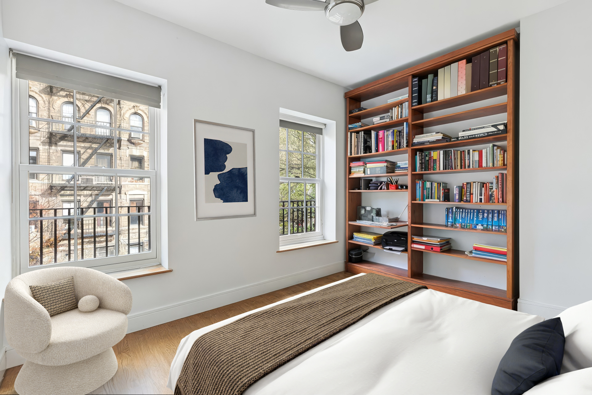 220 East 5th Street, Unit PHE Manhattan, NY 10003 - Photo 9 of 11 a bedroom with furniture and a book shelf