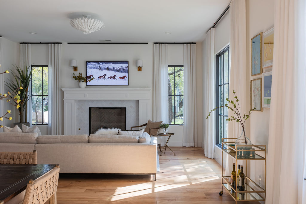 400 Inwood Road Austin, TX 78746 - Photo 7 of 43 a living room with furniture a fireplace and a flat screen tv