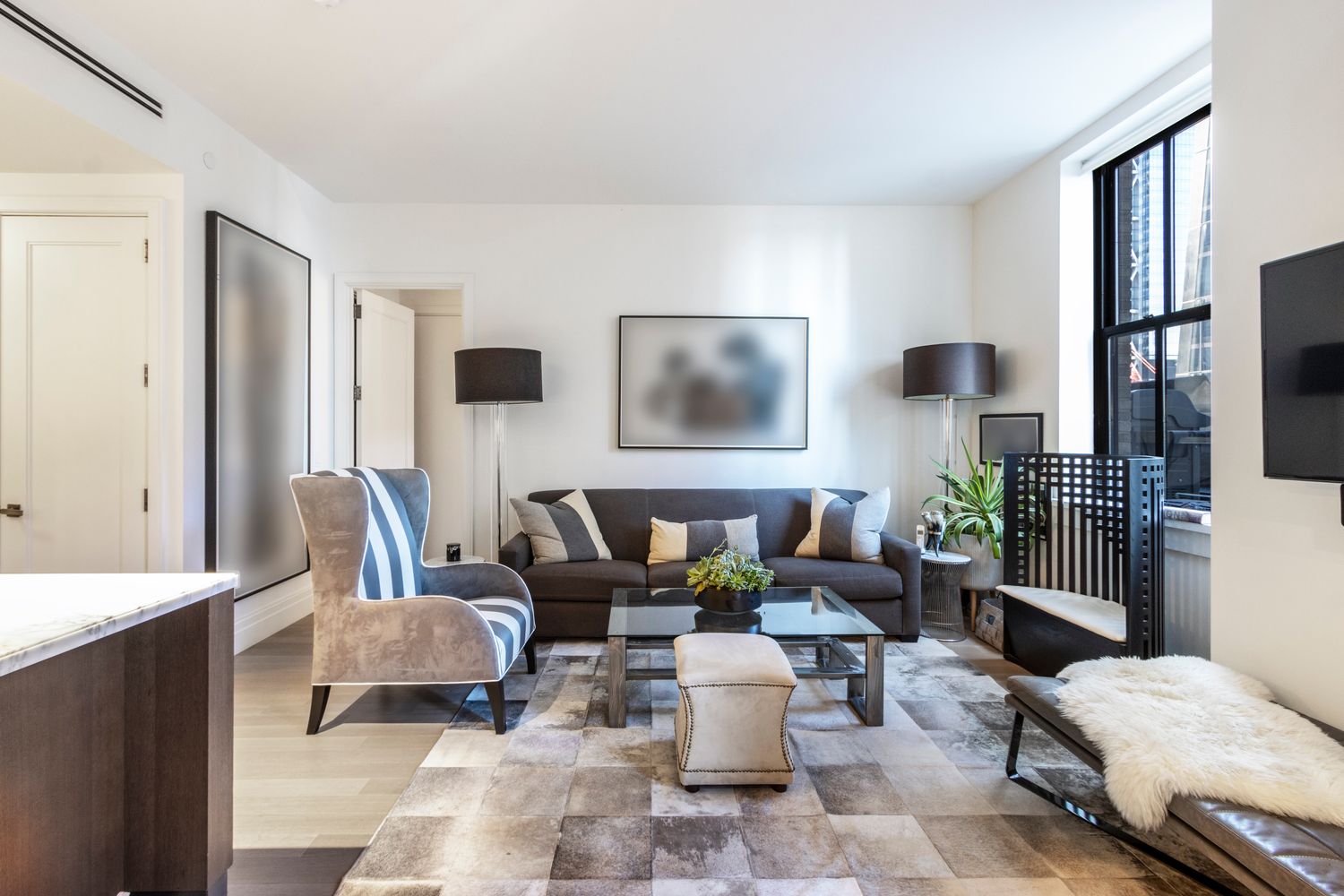 100 Barclay Street, Unit 14M Manhattan, NY 10007 - Photo 6 of 19 a living room with furniture and a flat screen tv