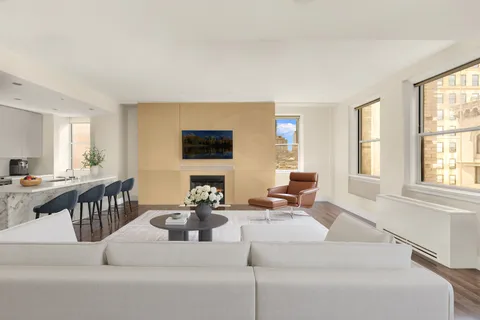 a living room with fireplace furniture and a flat screen tv