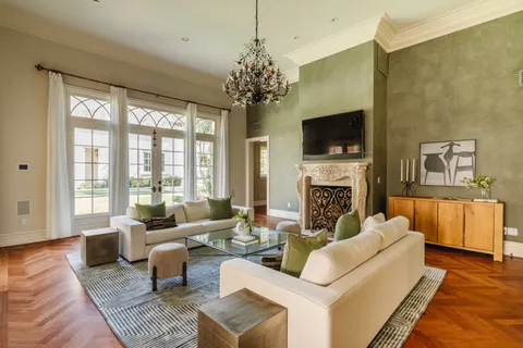 a living room with fireplace furniture and a flat screen tv