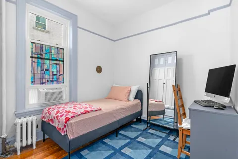 a bedroom with a bed and a desk