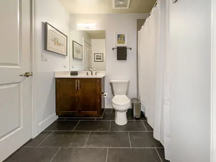 a bathroom with a toilet a sink and mirror