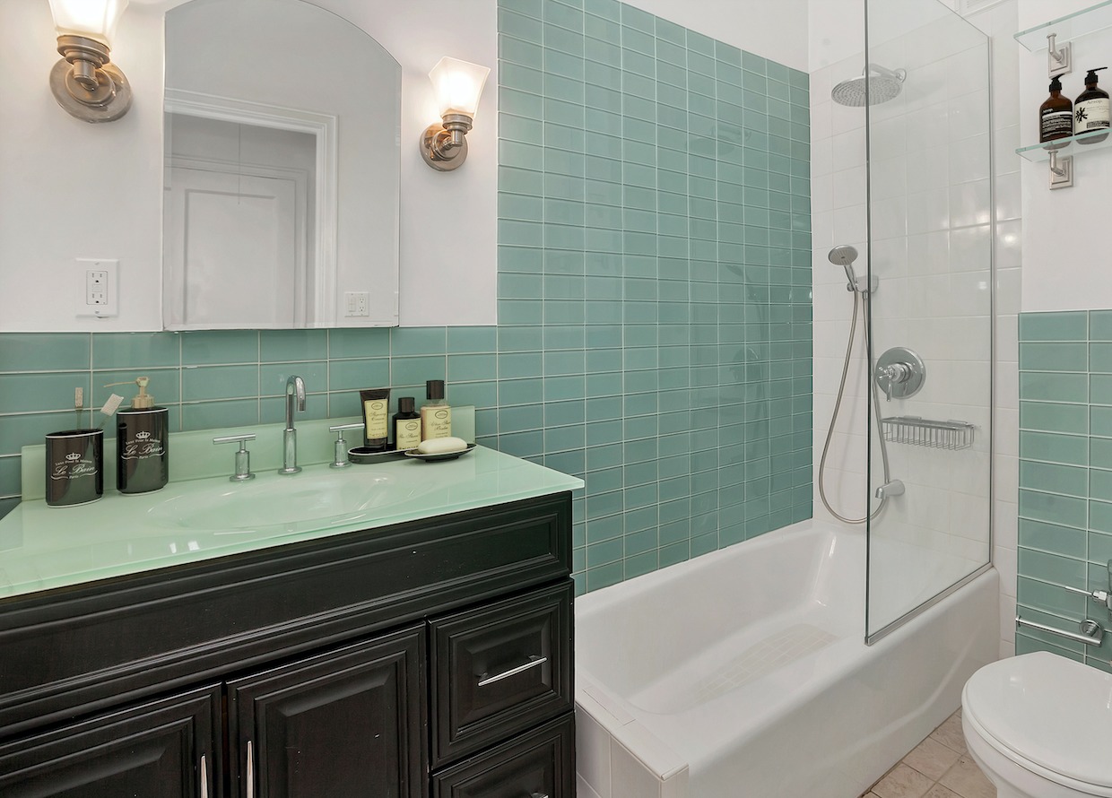 205 West 54th Street, Unit 2E Manhattan, NY 10019 - Photo 8 of 11 a bathroom with a sink a toilet and shower