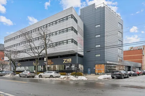 a building with car parked in front of it