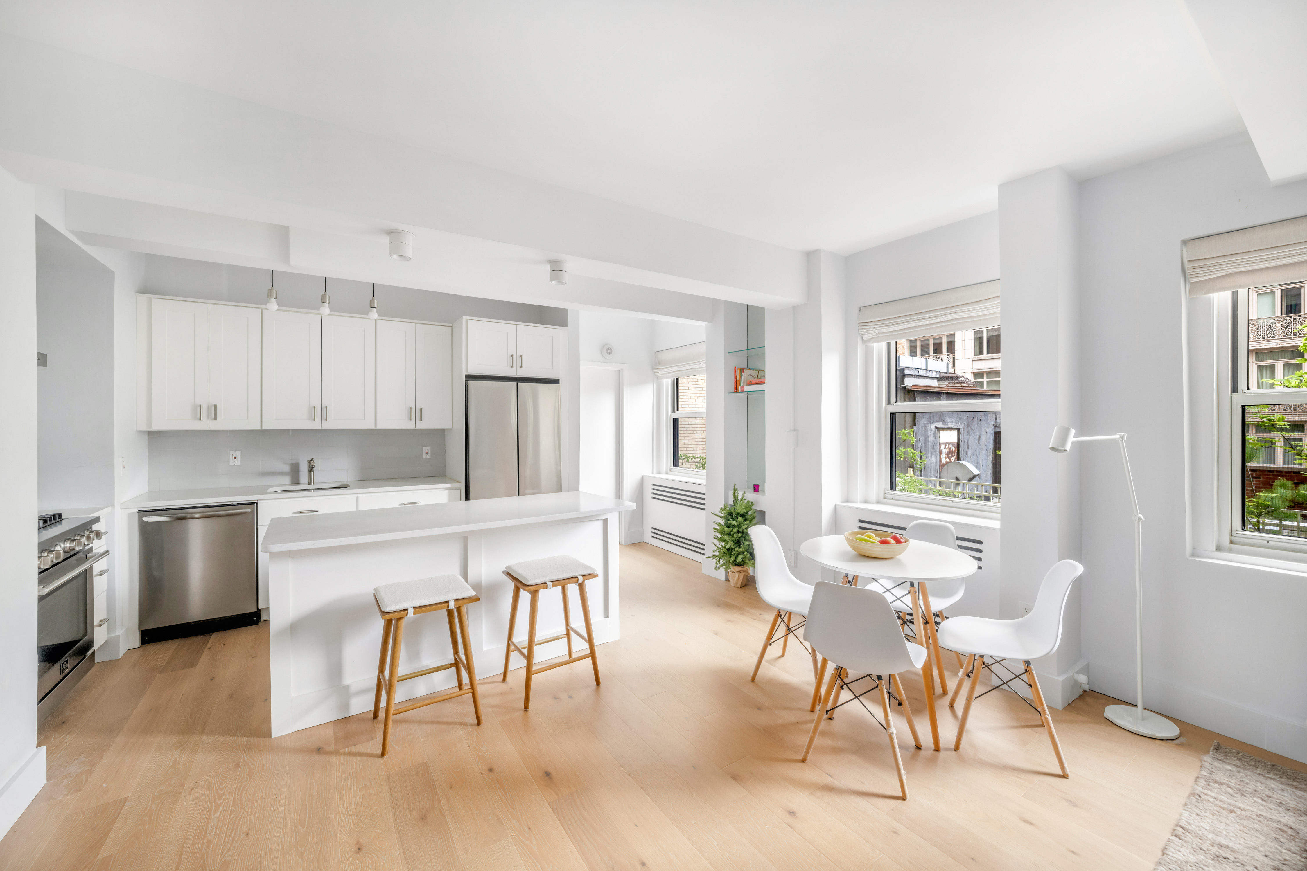2166 Broadway, Unit 5C Manhattan, NY 10024 - Photo 2 of 11 a kitchen with a dining table chairs and refrigerator