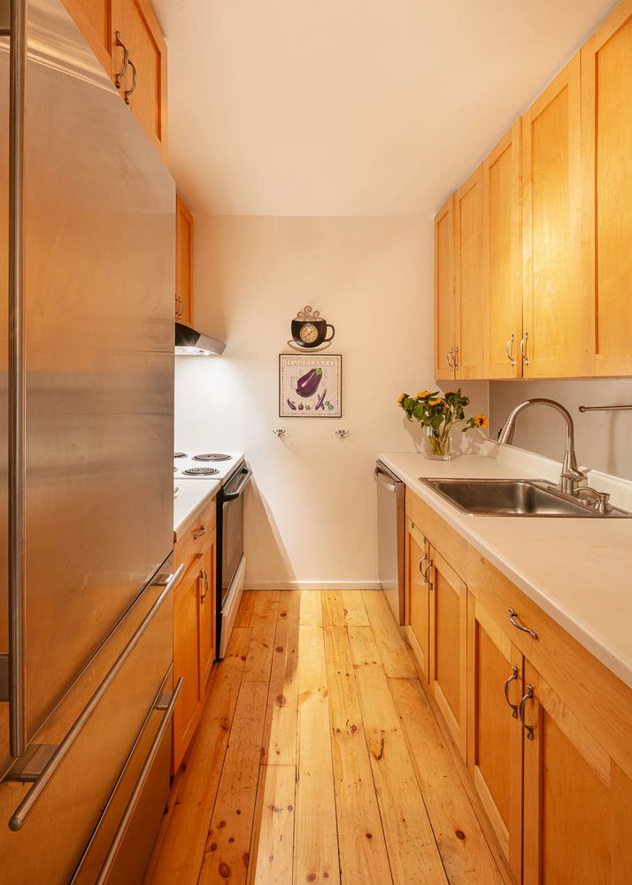 129 Barrow Street, Unit 3A Manhattan, NY 10014 - Photo 7 of 10 a spacious bathroom with a sink and mirror