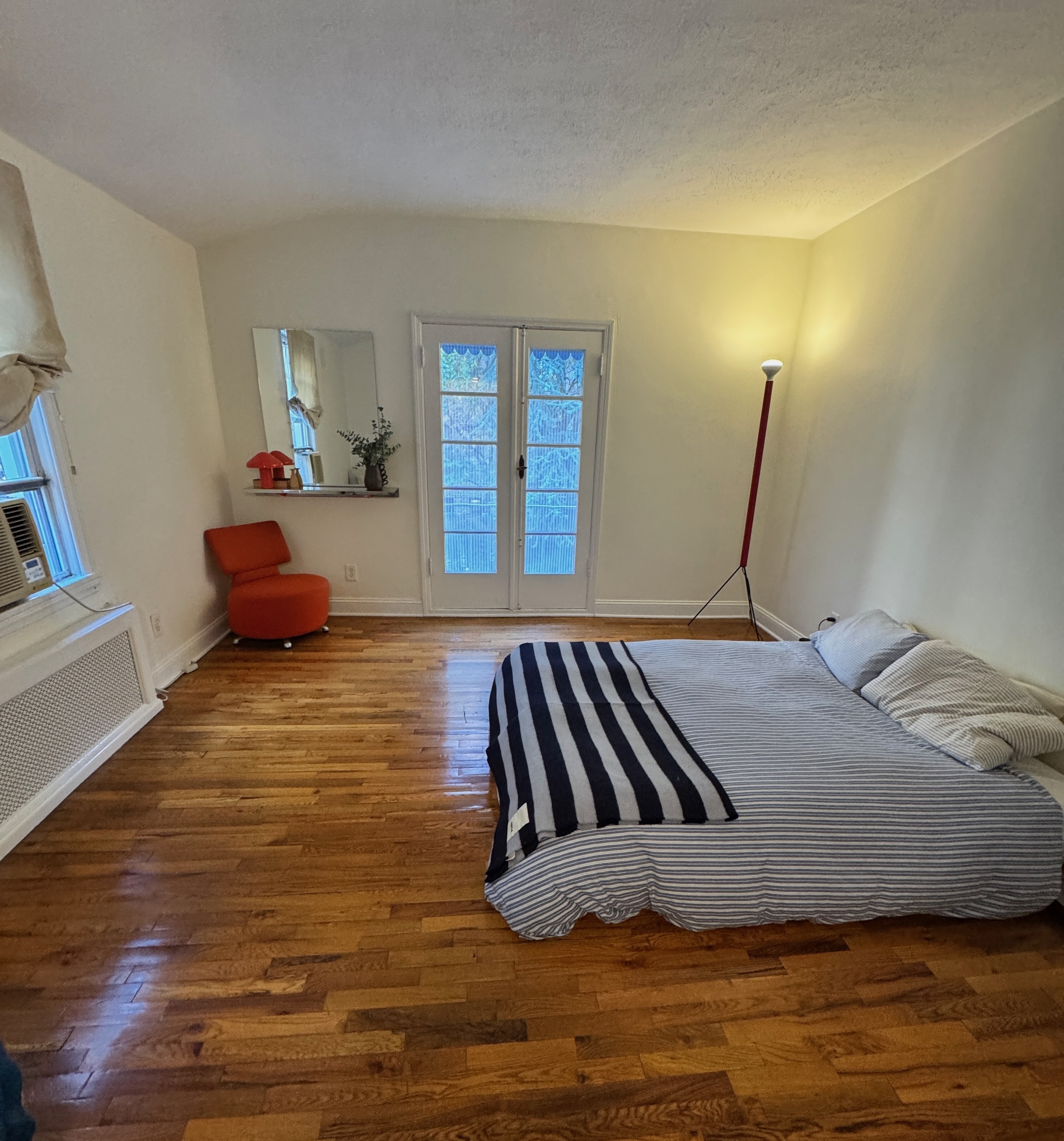 19 Vandam Street, Unit 2 Manhattan, NY 10014 - Photo 12 of 19 a bedroom with a bed and wooden floor