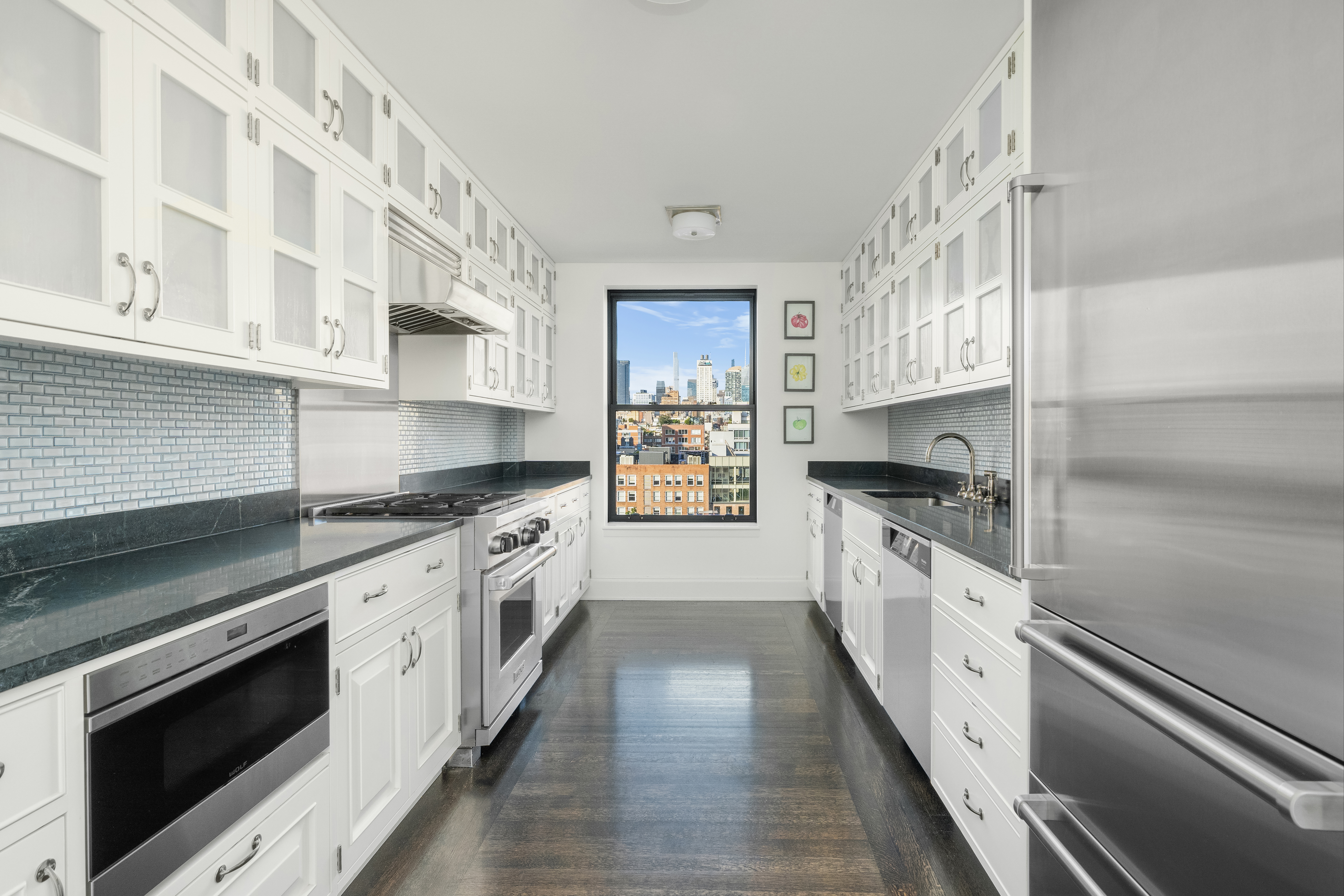 150 West 12th Street, Unit 11E Manhattan, NY 10011 - Photo 6 of 15 a large kitchen with stainless steel appliances granite countertop a stove and a sink