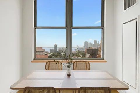 a bedroom with a large bed and a large window