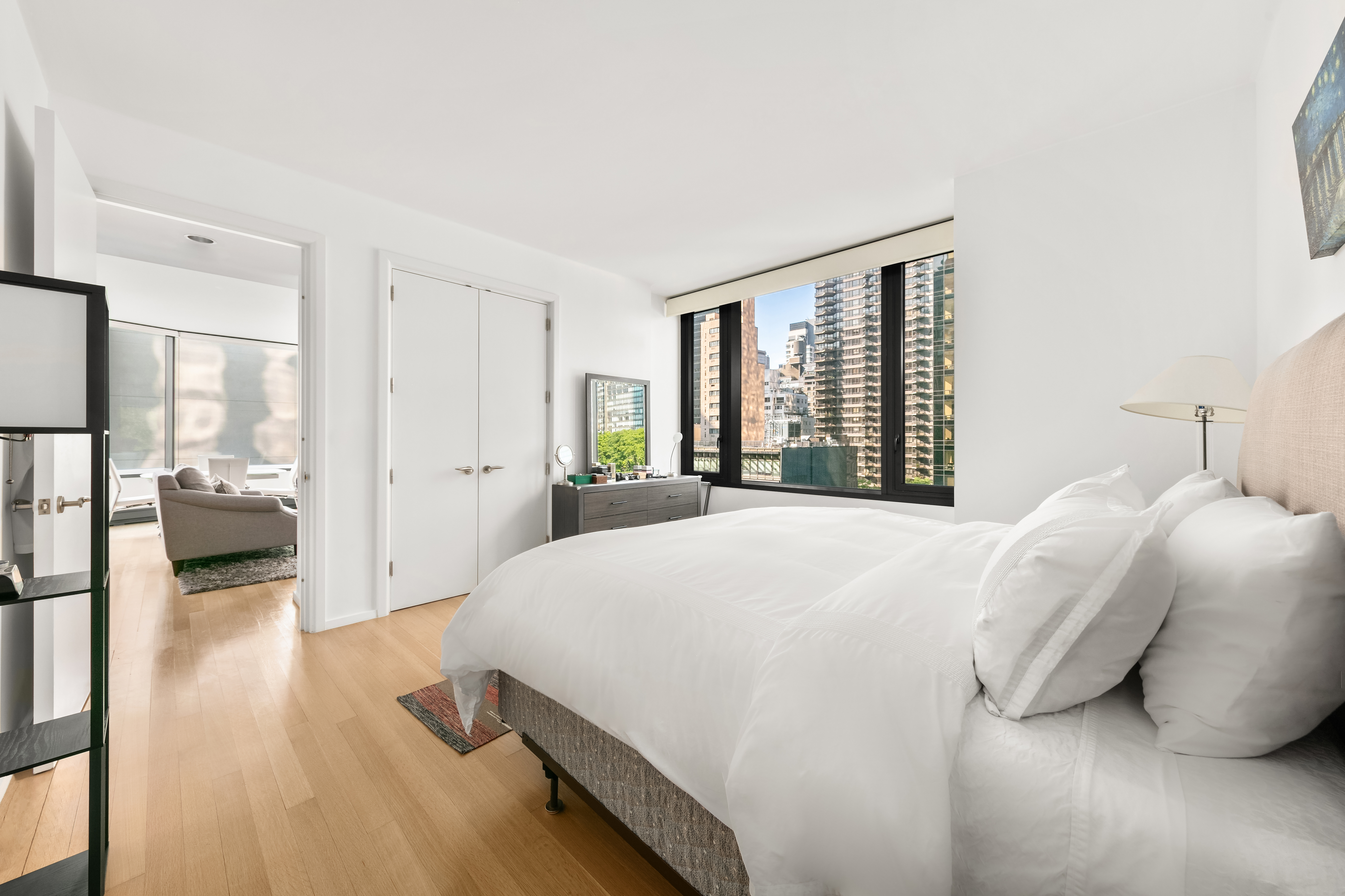 50 United Nations Plaza, Unit 6C Manhattan, NY 10017 - Photo 6 of 15 a bedroom with a bed and a large window