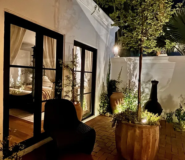 a living room with furniture and a floor to ceiling window