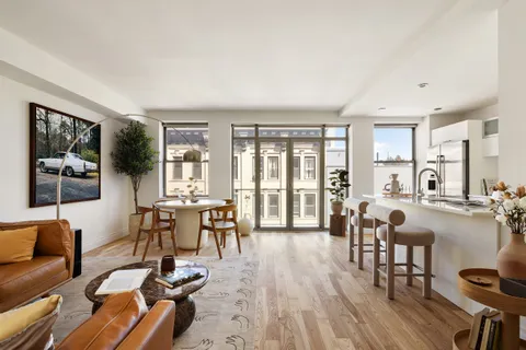 a living room with furniture and floor to ceiling windows