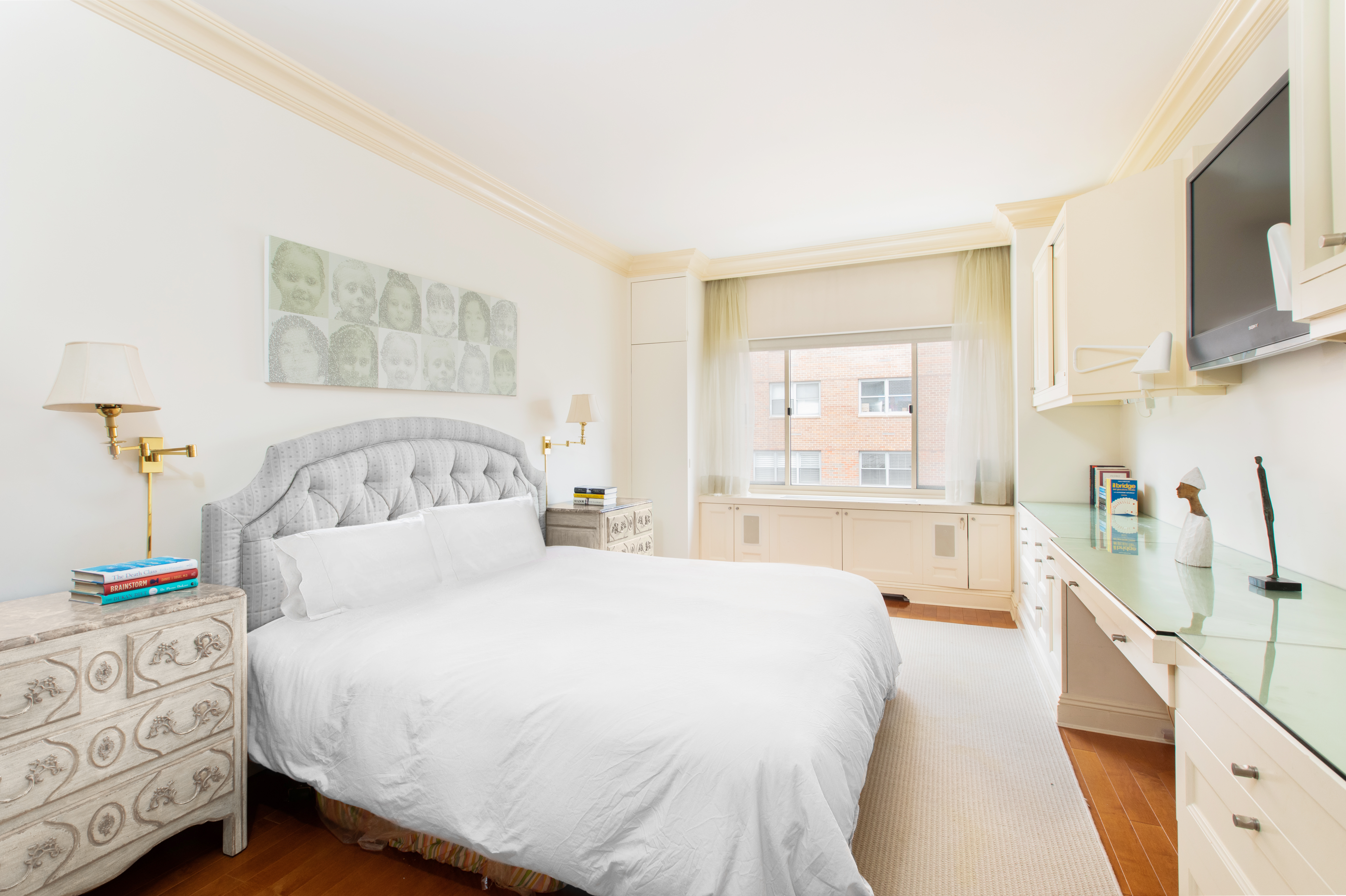 30 East 65th Street, Unit 12B Manhattan, NY 10065 - Photo 6 of 12 a bedroom with a large bed and a window