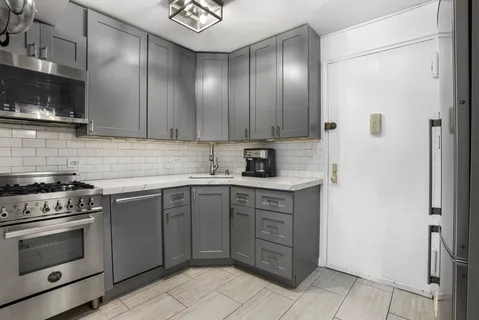 a kitchen with stainless steel appliances granite countertop a stove and a sink