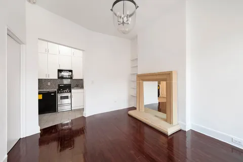 a kitchen with a refrigerator and a stove top oven