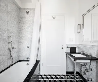 a bathroom with a granite countertop sink and a bathtub