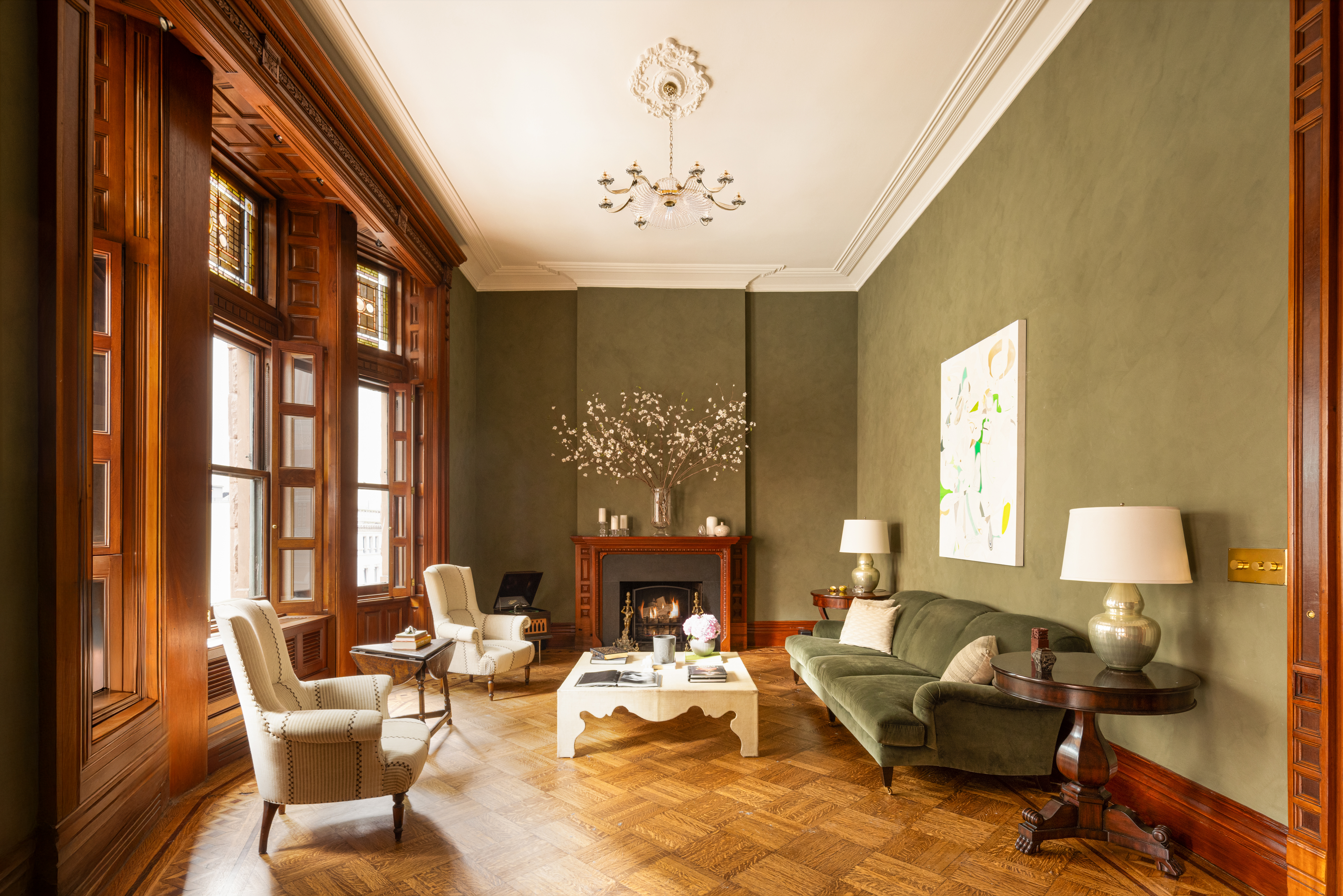 205 West 57th Street, Unit 4B Manhattan, NY 10019 - Photo 2 of 14 a living room with fireplace furniture chandelier and a large window