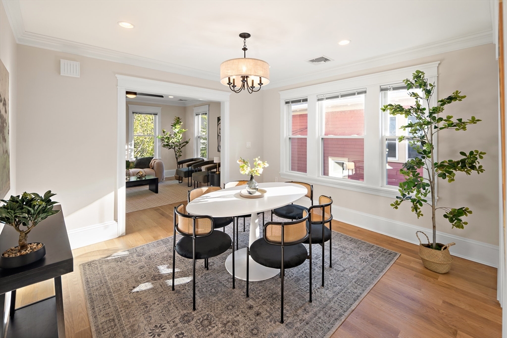 48-50 Amsden Street, Unit 2 Arlington, MA 02474 - Photo 7 of 34 a view of a dining room with furniture wooden floor and a chandelier
