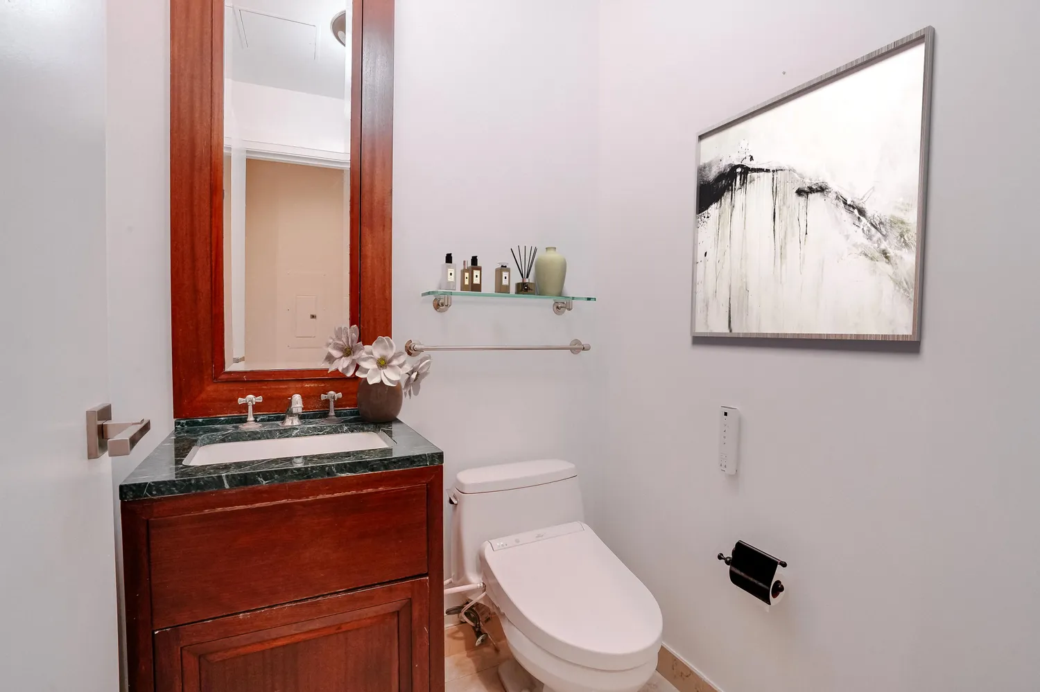 a bathroom with a toilet a sink and mirror
