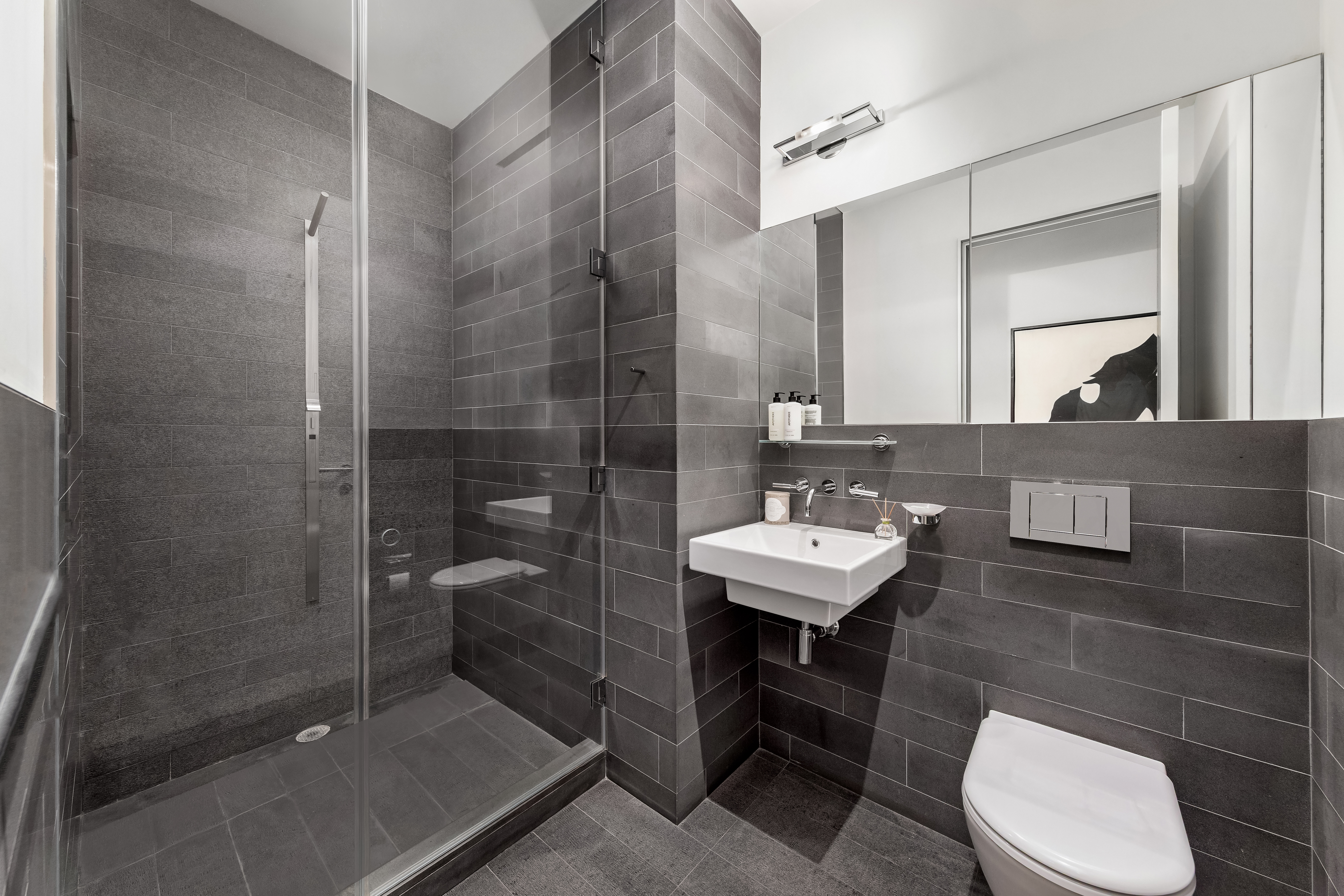 33 Vestry Street Manhattan, NY 10013 - Photo 12 of 16 a bathroom with a sink a toilet and shower