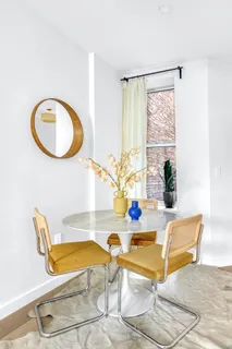 a dining room with table and chairs